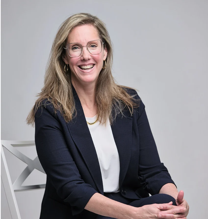 Elizabeth Sparks-Holmes seated and smiling in a campaign portrait.